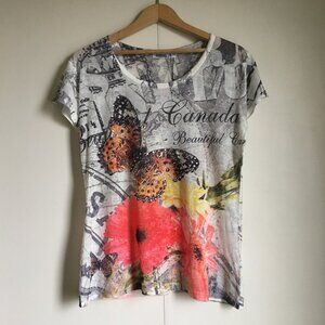 NWT Snowcap Whimsical Canadian Collage Butterfly + Travel Print Canadian Tee